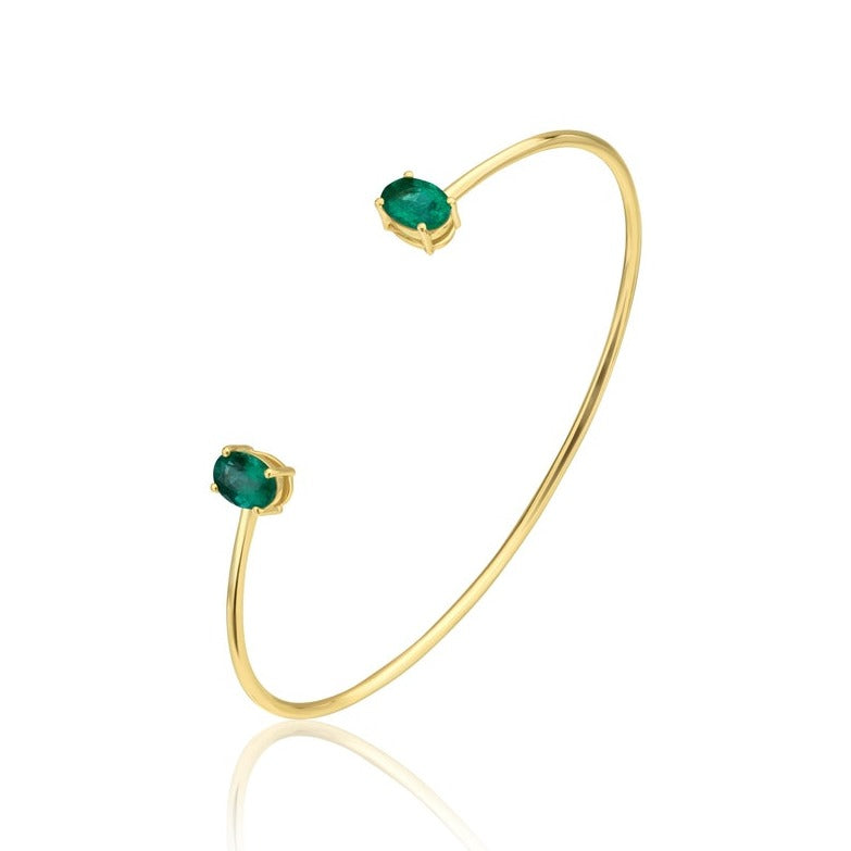 14k yellow gold bangle set with a matching pair oval Cut emerald